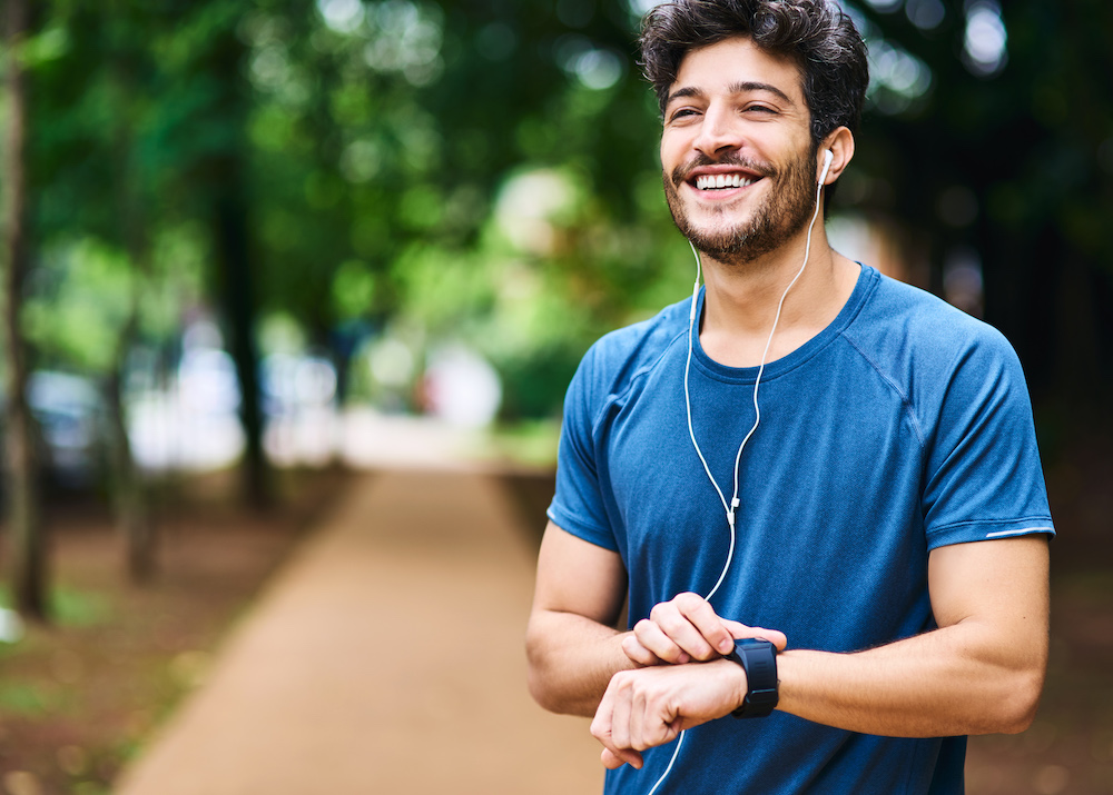 Man with earbuds in while jogging
